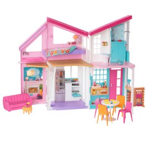 Two-story pink dollhouse playset with furniture and accessories"