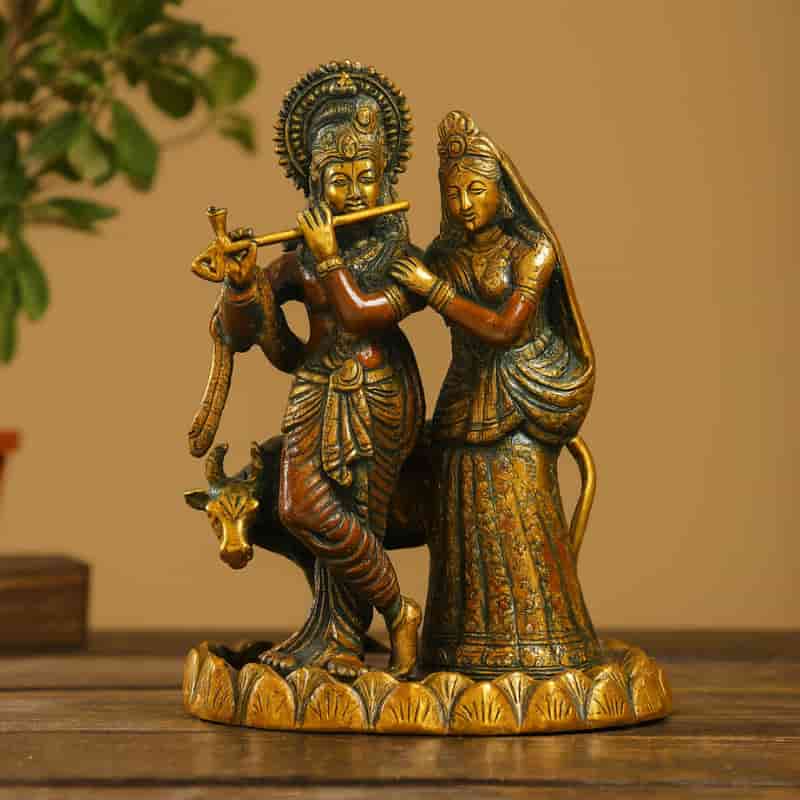 Brass idol of Radha and Krishna with a cow, standing on a lotus base, Krishna playing flute while Radha stands beside him, perfect for home decor, pooja, and gifting by Motumal Giftwala.