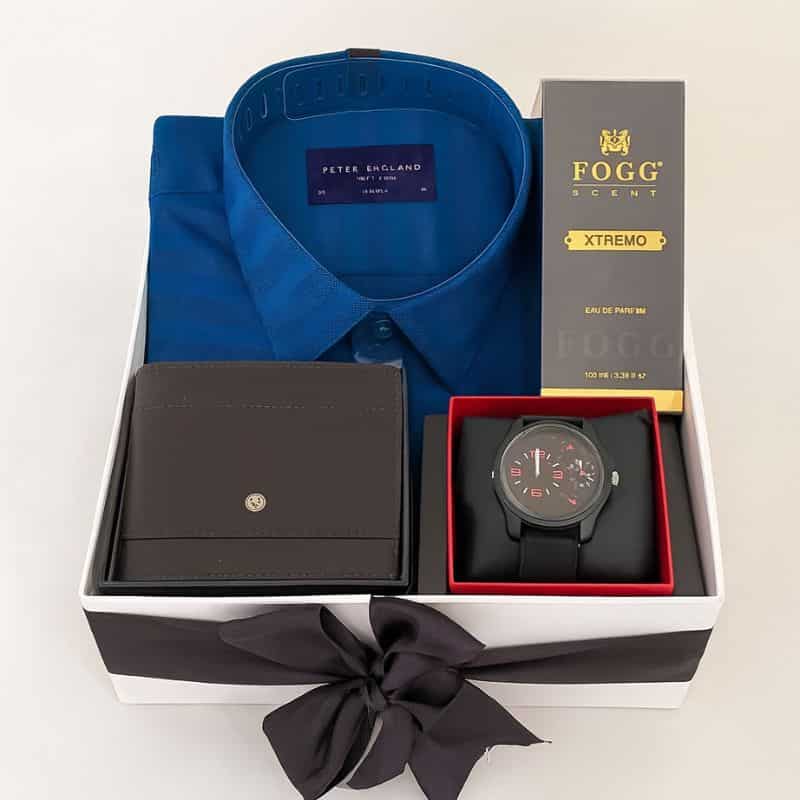 Premium men’s gift hamper featuring a Peter England blue shirt, leather wallet, stylish wristwatch, and Fogg Xtremo perfume, packed in an elegant ribbon box — luxury gifting set by Motumal Giftwala.