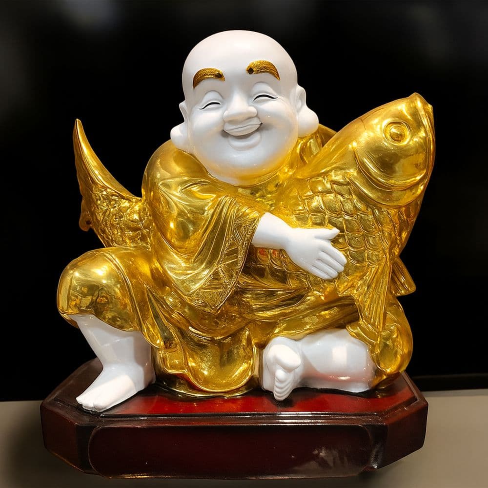 Golden Laughing Buddha showpiece holding a fish – premium gift for home decor in Ranchi from Motumal Giftwala