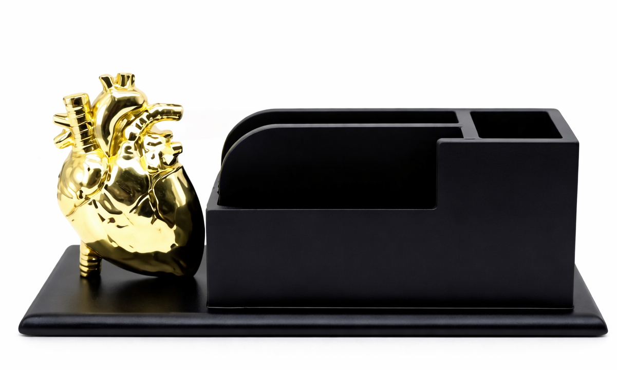 Black desk organizer with a gold anatomical heart on a white background