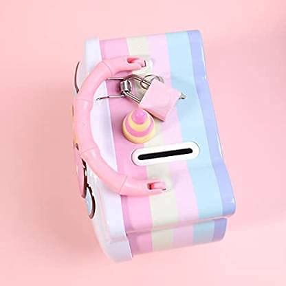 Pastel striped wallet with pink strap and keychain on a pink background
