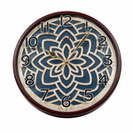 Decorative wall clock with floral design and brown frame on a white background