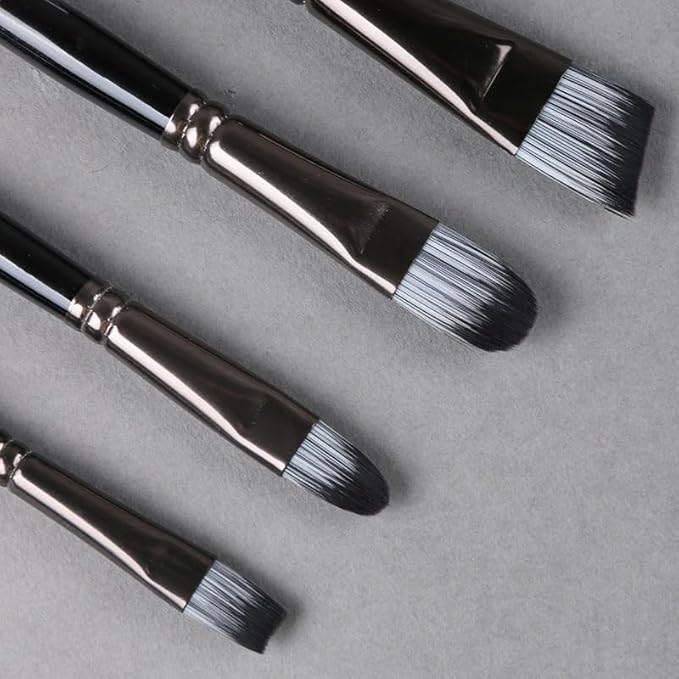 Set of black paintbrushes with silver ferrules on a gray background
