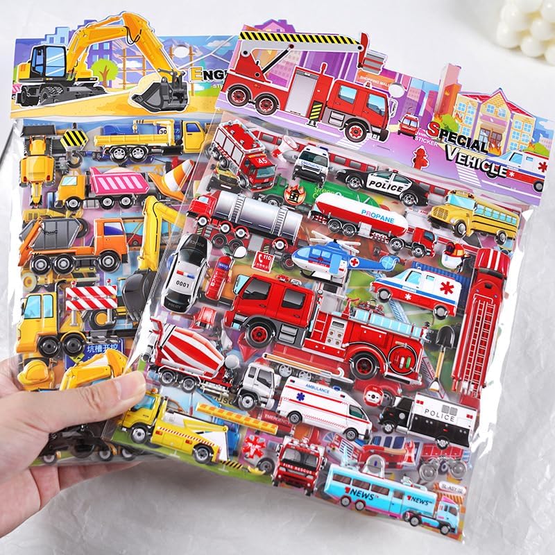 Children's sticker sheets with vehicles held by a hand on a light background