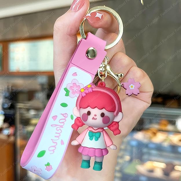 Keychain with a cartoon character held by a hand in a blurred indoor setting
