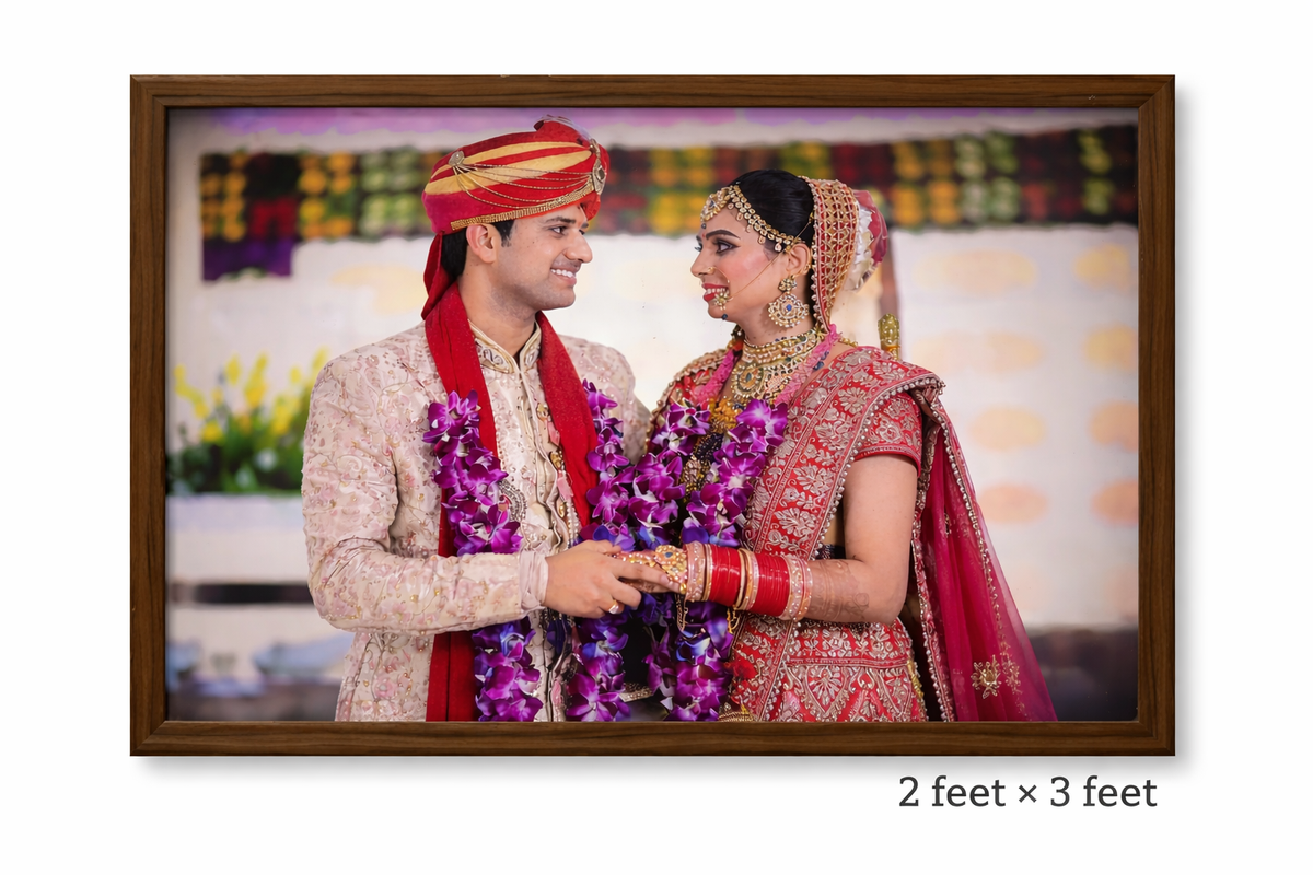 Framed photograph of a couple in traditional wedding attire with a colorful background.