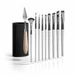 Set of paintbrushes with a black holder on a white background