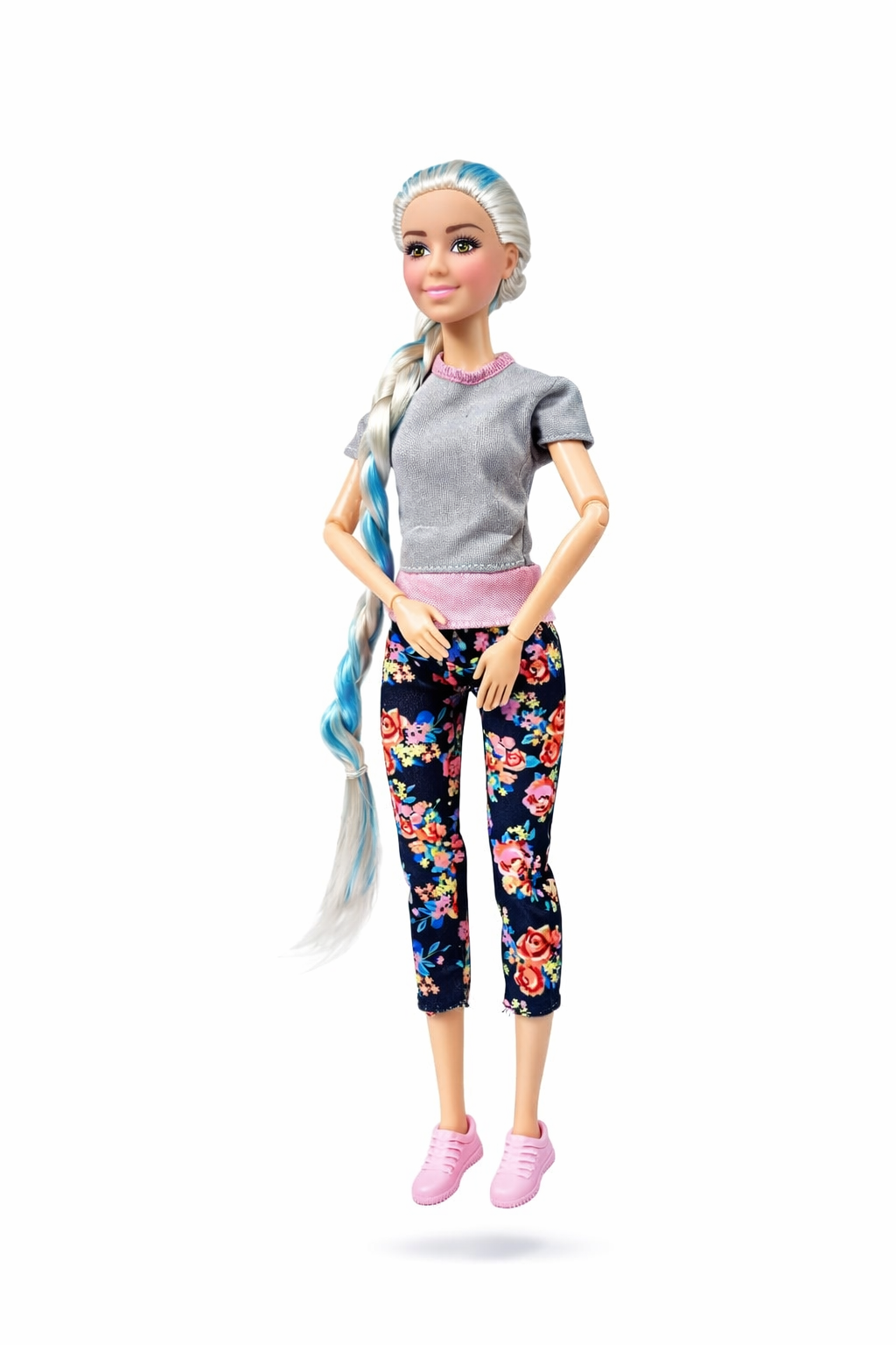 Barbie doll with floral leggings and gray shirt on a white background