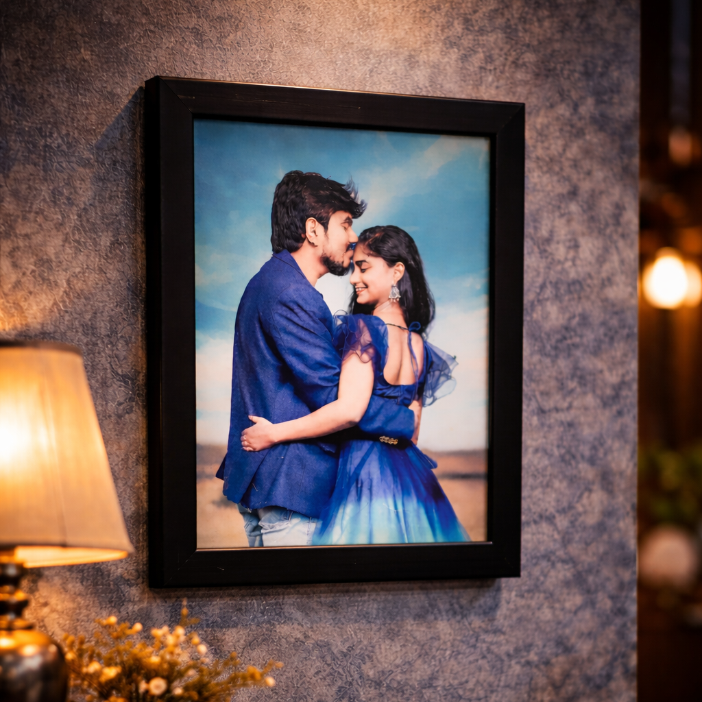 Framed photograph of a couple embracing on a wall with decorative elements.