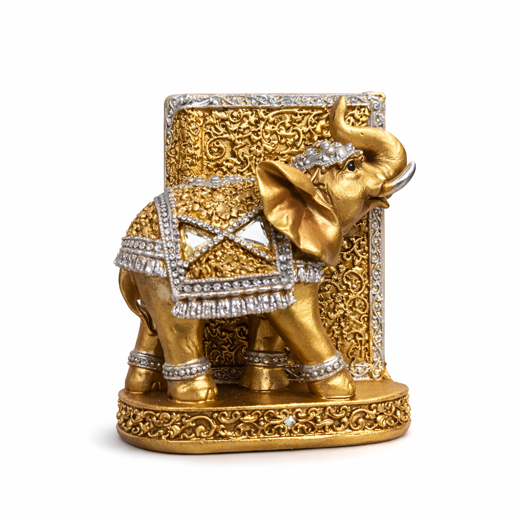Decorative gold elephant figurine with intricate designs on a white background