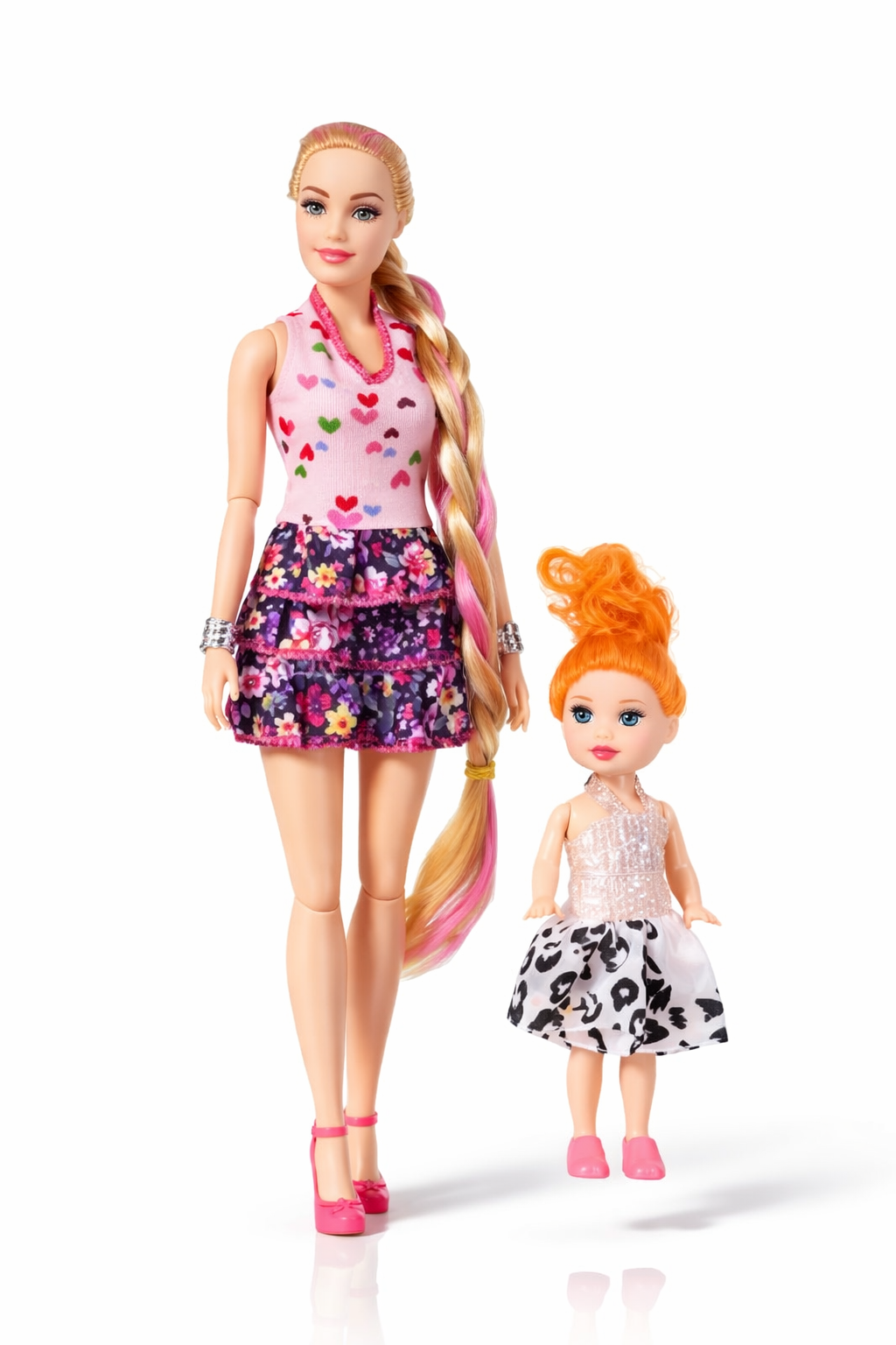 Two dolls, one taller with a colorful outfit and long hair, and one shorter with a polka dot dress and orange hair, on a white background.