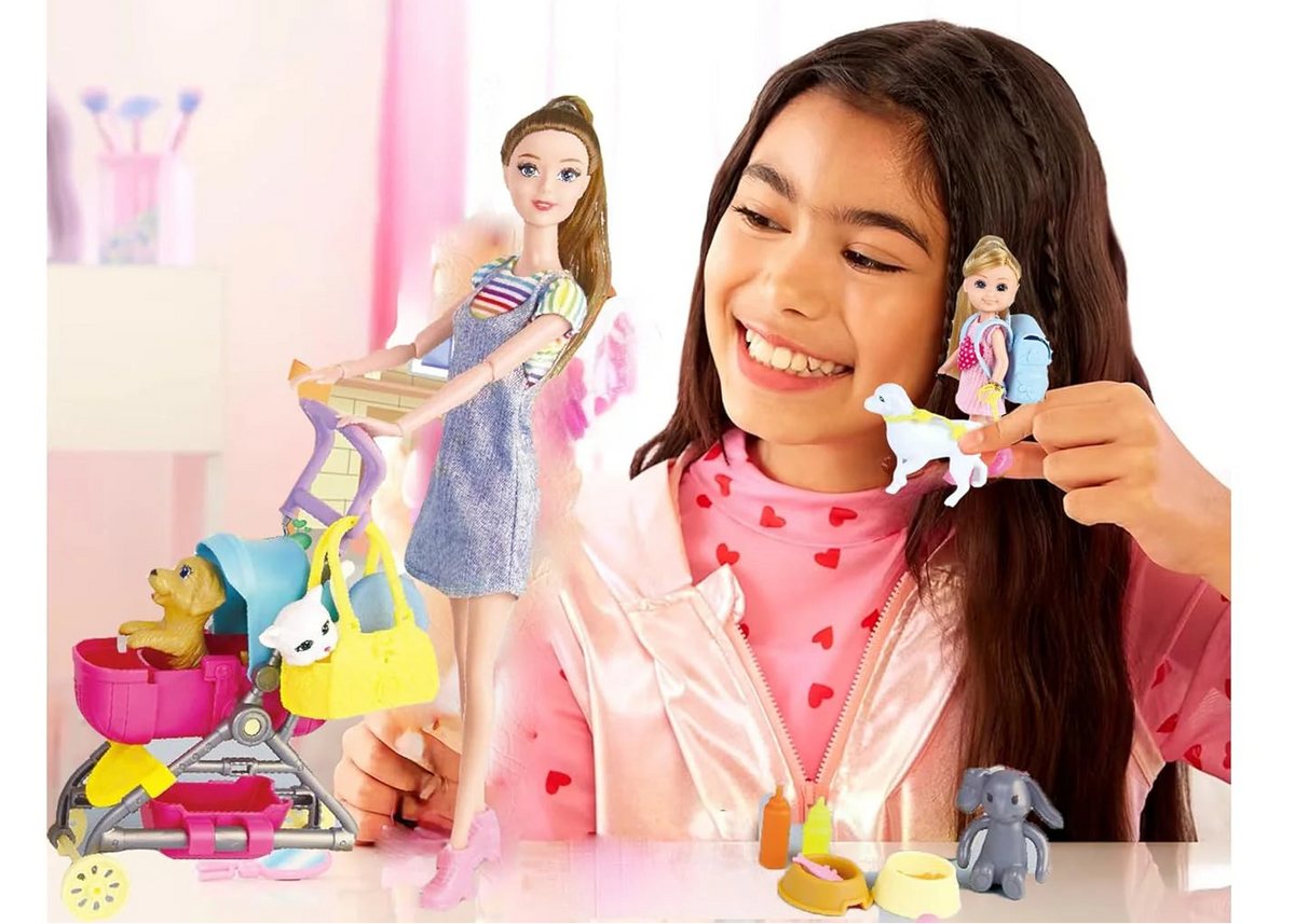 Young girl playing with dolls and toys in a room with pink walls.