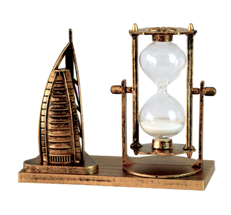 Decorative hourglass with a miniature model of a skyscraper on a white background