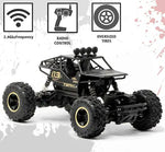 Black remote control monster truck with oversized tires on a white background
