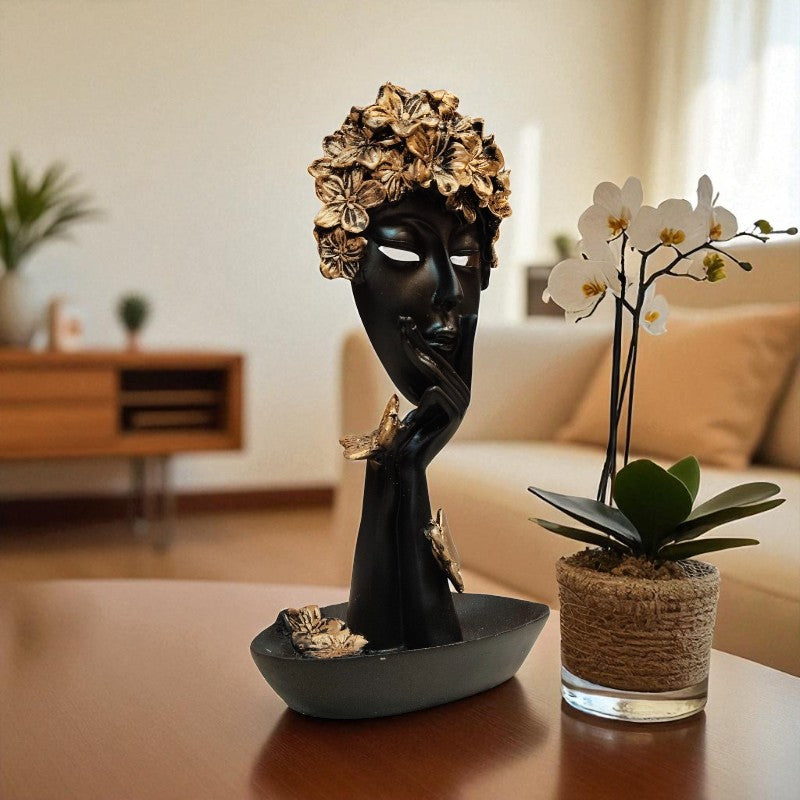 Decorative black mask with gold flowers on a table in a living room setting