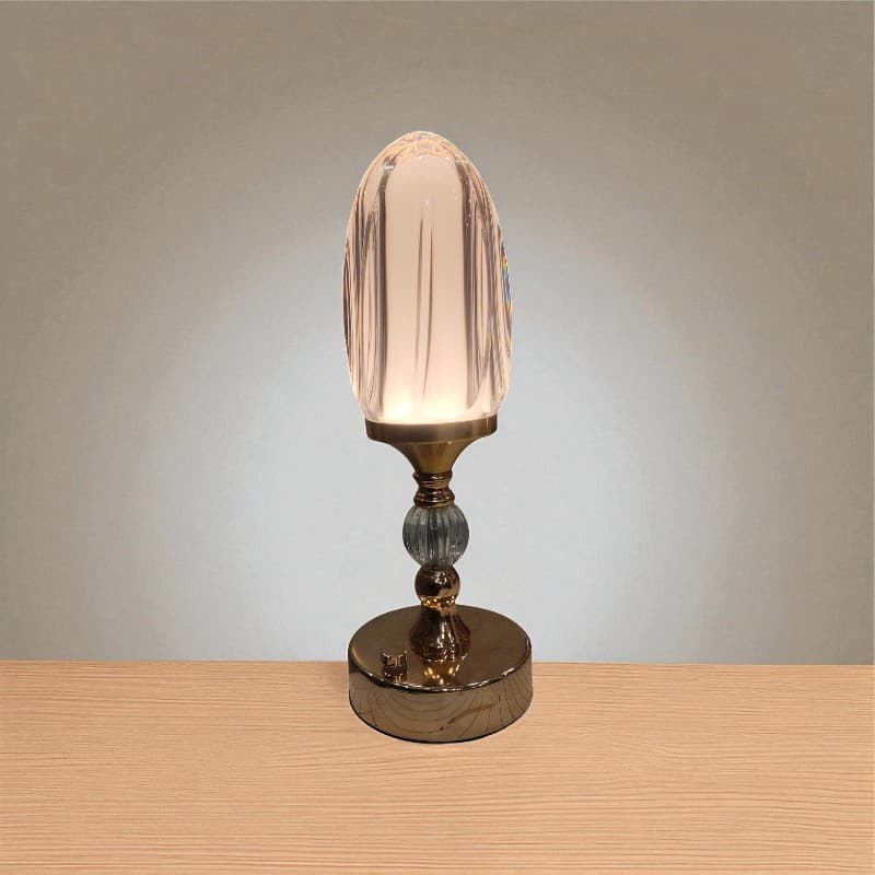 Decorative table lamp with a glass shade on a wooden surface