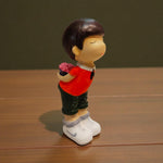 Cute boy figurine holding flower resin showpiece – Motumal Giftwala
