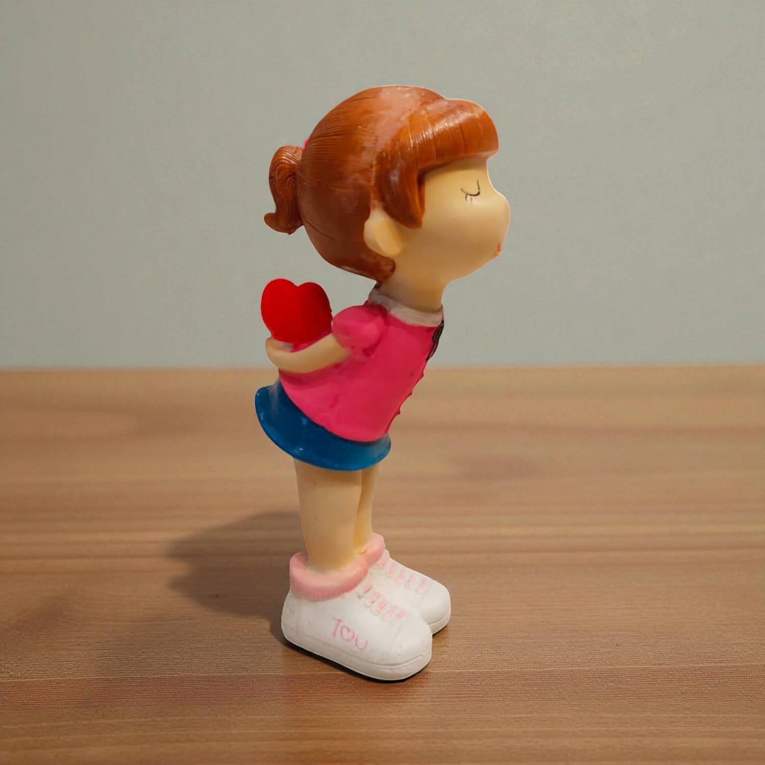 Cute girl figurine holding heart – romantic showpiece for gifting