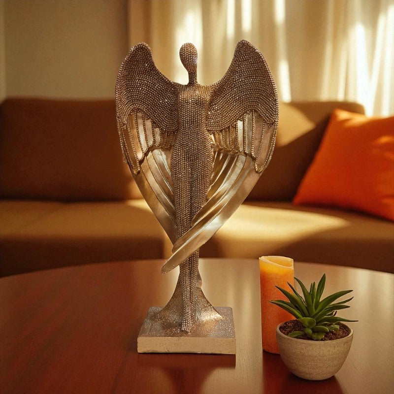 Decorative sculpture on a table with a candle and plant in a living room setting