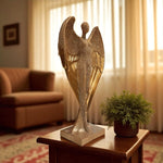 Decorative angel sculpture on a table with a plant in a living room setting