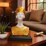 Decorative bust with gold and white attire on a table in a living room setting