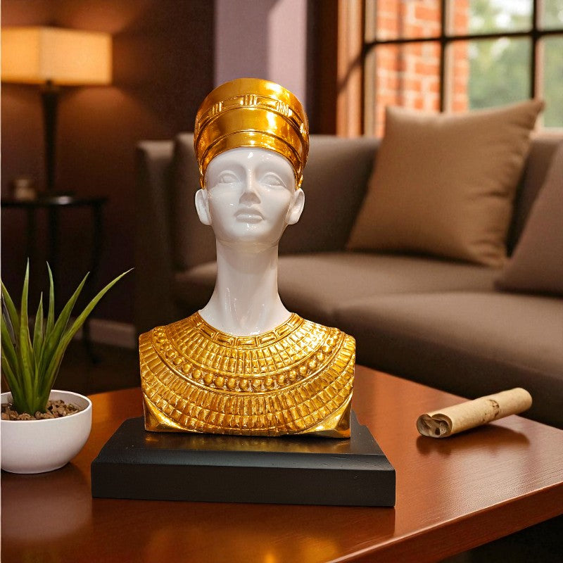 Decorative bust with gold and white attire on a table in a living room setting