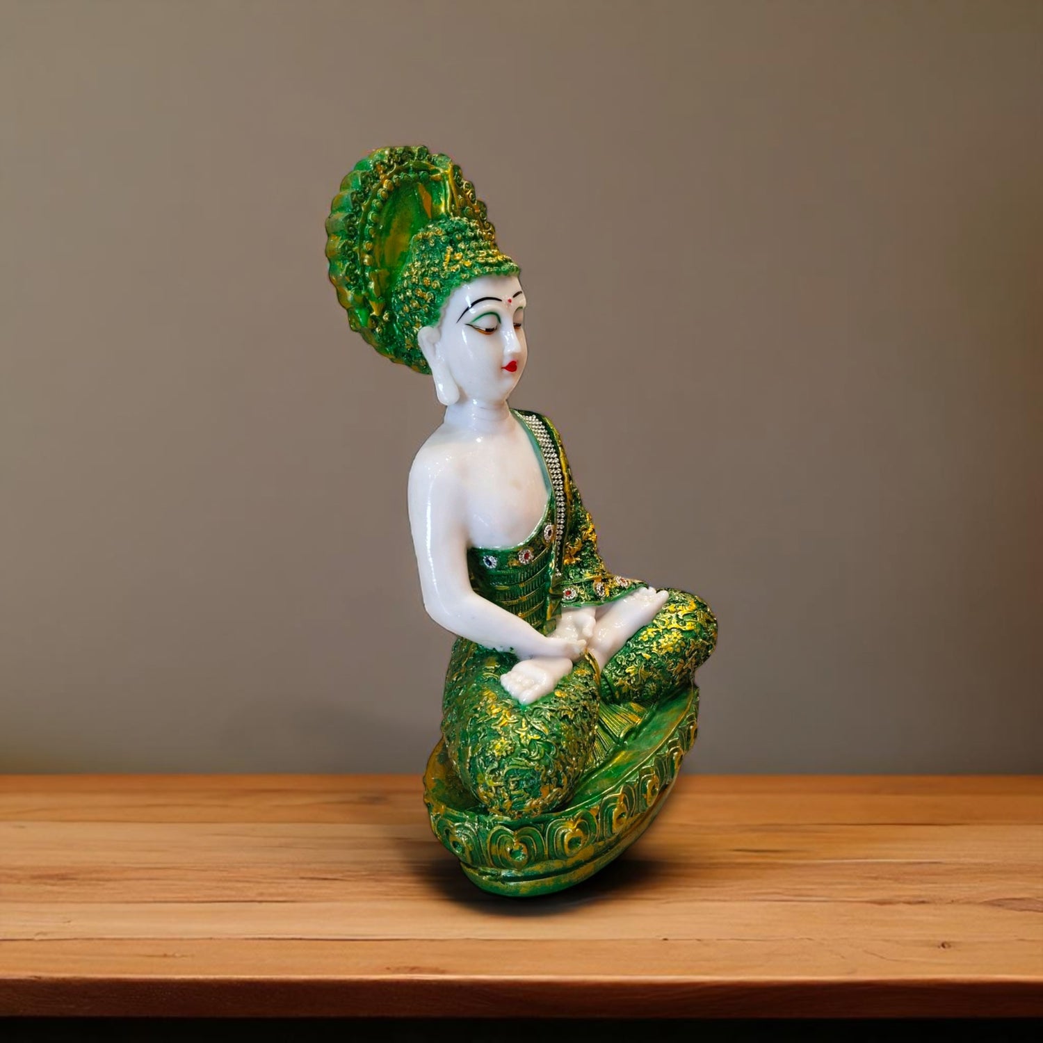  Side profile of green and golden meditating Buddha idol – spiritual gift item from Ranchi's Motumal Giftwala
