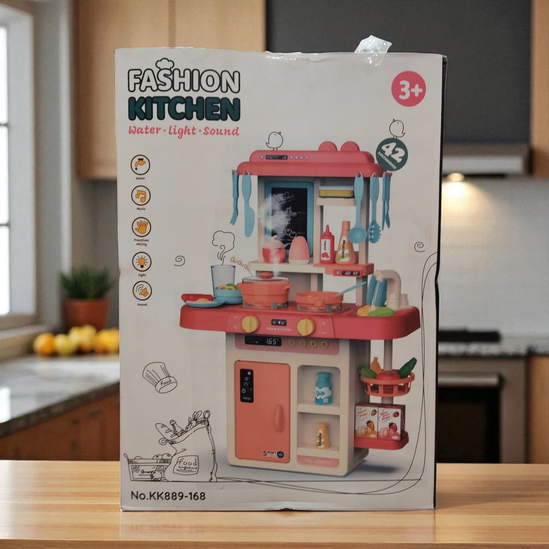 Fashion Kitchen playset box displayed upright, highlighting main toy kitchen with accessories and illustration icons.