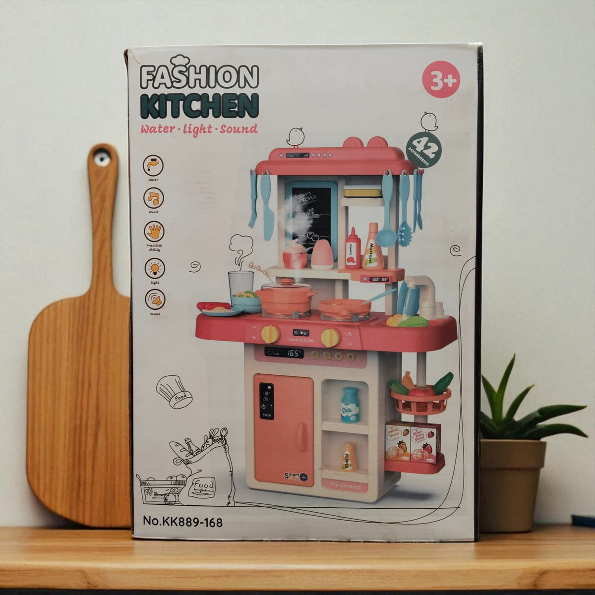 Front-facing image of Fashion Kitchen toy box featuring water, light, and sound functions, suitable for kids age 3+.