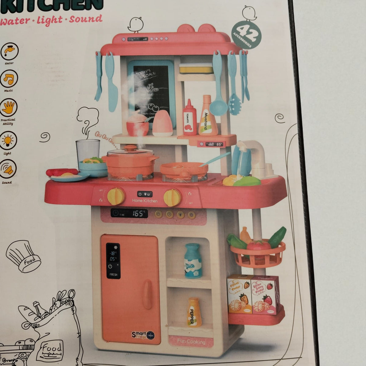 Close-up view of Fashion Kitchen playset showing pink stove, utensils, pretend sink, and colorful accessories.