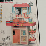 Close-up view of Fashion Kitchen playset showing pink stove, utensils, pretend sink, and colorful accessories.