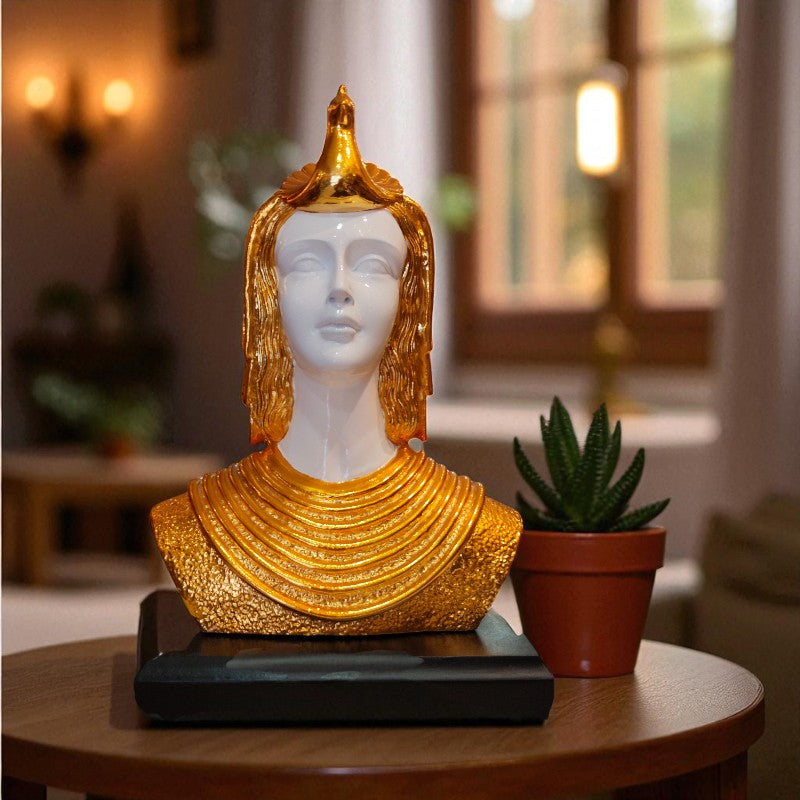 Decorative bust with gold and white details on a table in a home setting