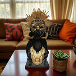 Decorative bust with gold and black details on a table in a living room setting.