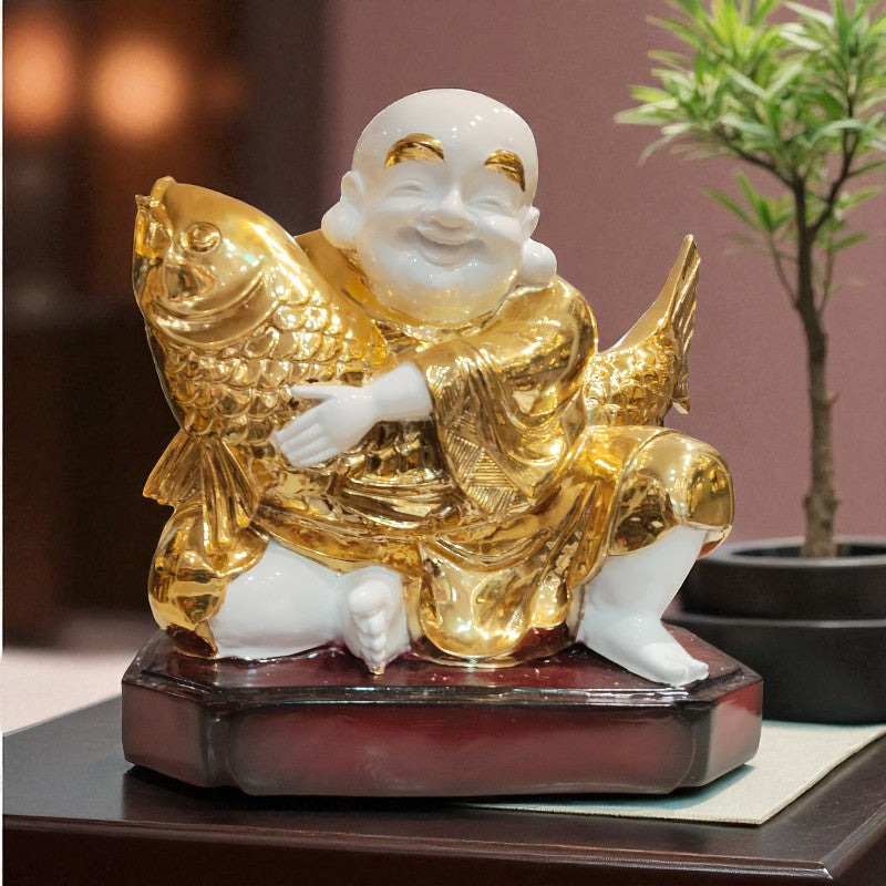 Gold fish-shaped incense burner on a wooden table with a soft focus background