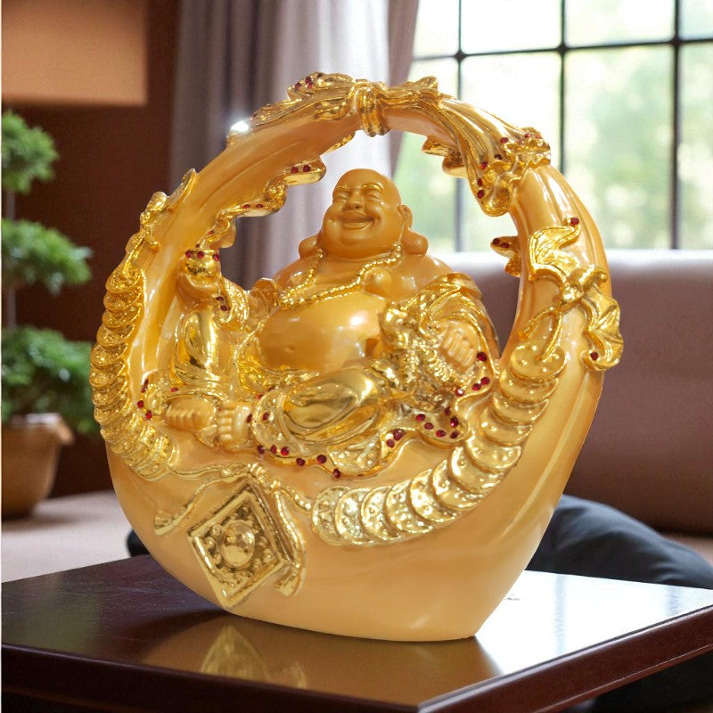 Decorative golden sculpture of a laughing Buddha on a table with a blurred indoor background