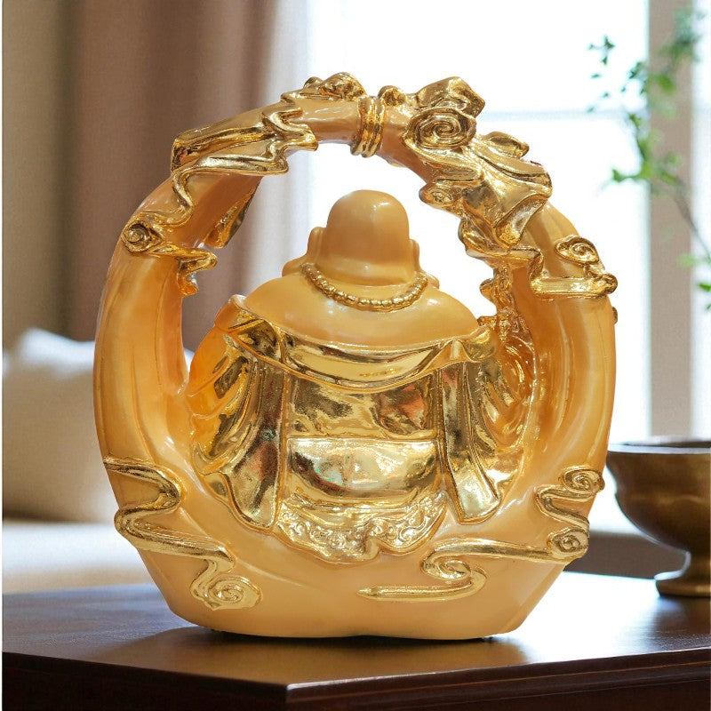 Decorative golden Buddha statue on a table with a blurred background