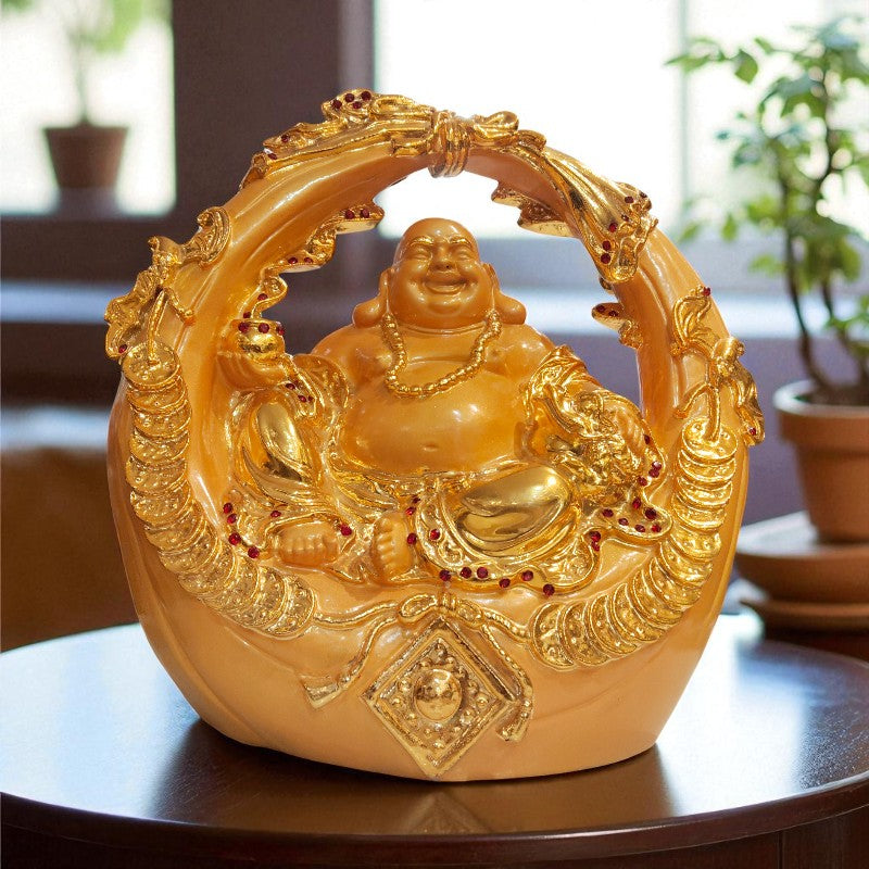 Gold Buddha statue with intricate designs on a wooden table