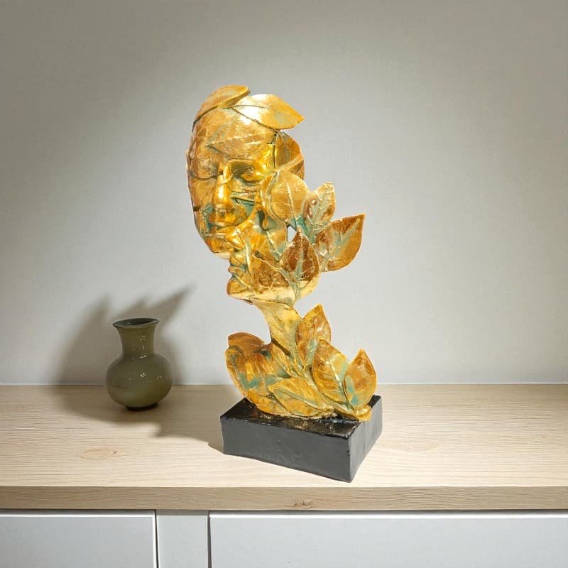 Decorative stone sculpture on a wooden surface with a plain background