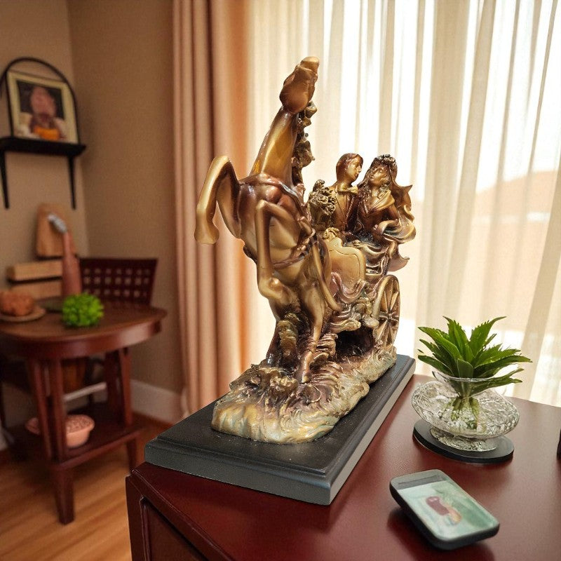 Decorative statue on a table with a phone and plant in a room setting