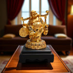 Front view of golden laughing buddha holding wealth coins and staff"