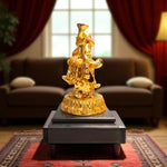 Side view of laughing buddha idol with prosperity tools"