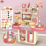 Toy kitchen set with various accessories on a pink background