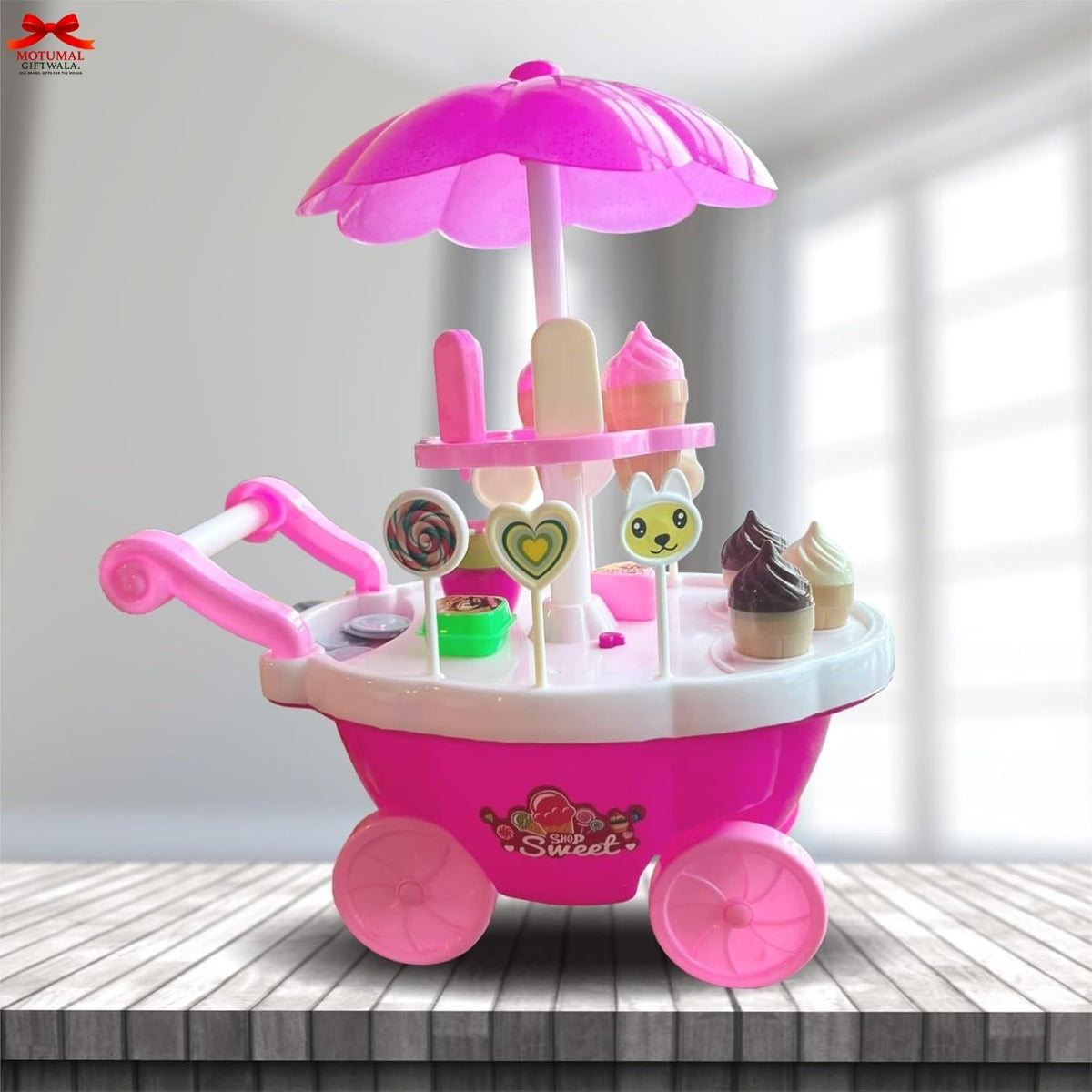 Pink toy ice cream cart with various ice cream cones on a wooden surface.