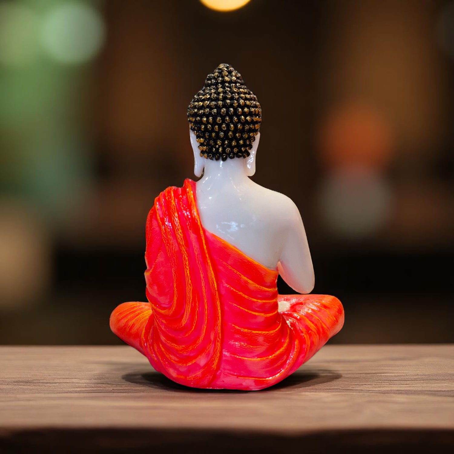 Orange Buddha Idol back view on wooden table – Motumal Giftwala