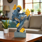Decorative sculpture with blue and gold elements on a table in a living room setting