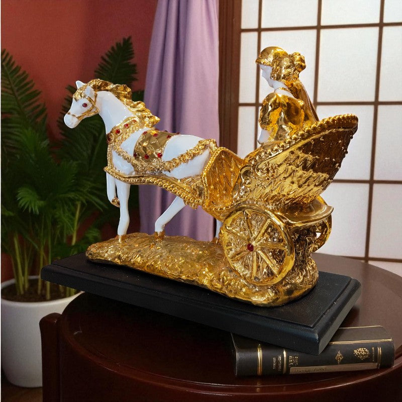 Decorative sculpture of a horse pulling a chariot with gold accents on a dark surface.