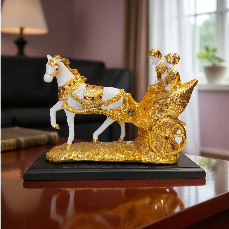 Decorative figurine of a white horse with a gold carriage and figures on a table.