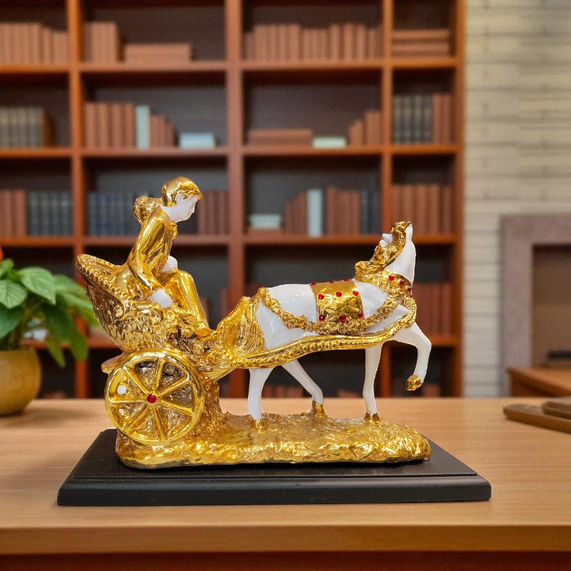 Decorative figure of a chariot with a horse on a wooden table in front of a bookshelf.