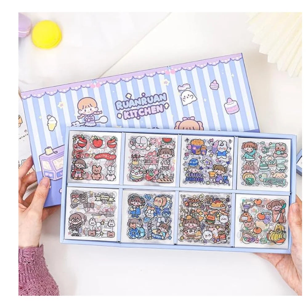 Sticker book with cute illustrations and 'Ruan Ruan Kitchen' branding held by a person.